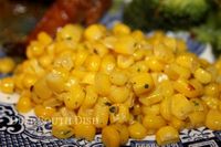 Frozen or canned corn, dressed up with a little butter, salt and pepper and fresh parsley. A traditional holiday side dish in my family.