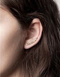 A pair of curved, whale-tusk inspired ear pins from Knobbly Studio featuring delicate hammered texture and post backs. �€�	Curved, whale-tuck inspired ear pins �€�